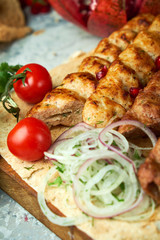 Plates of meat with barbecue and kebab, top view on gray background