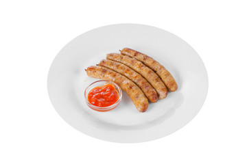 Four grilled sausages without garnish with tomato, spicy, red sauce, ketchup on a plate, isolated on white background, side view