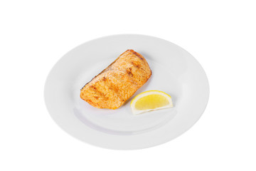 Fish, trout, keta, pink salmon, a piece, baked, fried over an open fire with a slice of lemon. Appetizing on white isolated background side view
