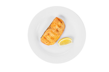 Fish, trout, keta, pink salmon, a piece, baked, fried over an open fire with a slice of lemon. Appetizing on white isolated background view from above