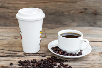 Roasted coffee beans with white coffee cup
