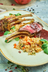 grilled lamb chops and risotto on a plate 