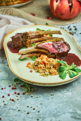 grilled lamb chops and risotto on a plate 