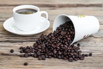 Roasted coffee beans with white coffee cup