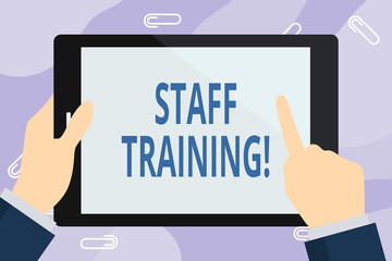 Handwriting text writing Staff Training. Conceptual photo program that is designed to increase the technical skills Businessman Hand Holding, Pointing and Touching Colorful Tablet Blank Screen