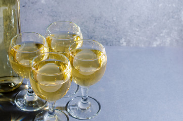 White wine in glass wine glasses, a bottle of wine. Blue background. Copy space