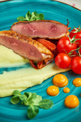 Fried meat with shredded potatoes and tomatoes 