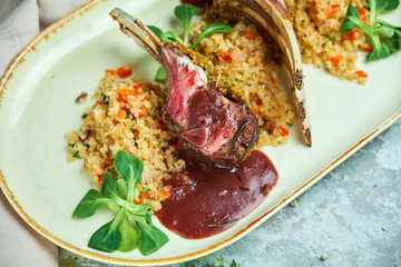 grilled lamb chops and risotto on a plate 