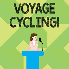 Writing note showing Voyage Cycling. Business concept for Use of bicycles for transport recreation and exercise Businesswoman Behind Podium Rostrum Speaking on Microphone