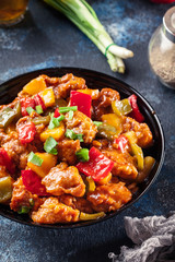 Sweet and sour chicken with colorful bell pepper on a plate