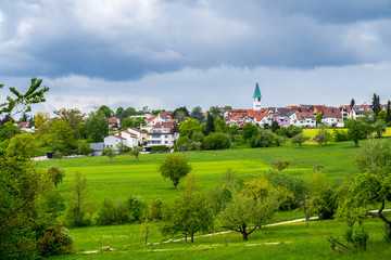 Fototapeta na wymiar Germany, Dreamy town ostfildern kemant behind green nature countryside in spring