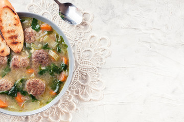 Italian wedding soup with meatballs and vegetables