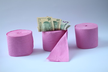 three pink rolls of toilet paper on a white background