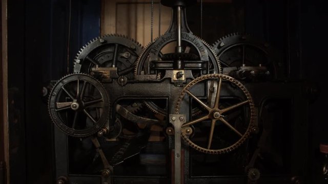  Old ancient medieval machine or clock with cogs in a bell tower