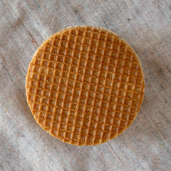 Top view, stack of homemade Dutch stroopwafels with honey-caramel filling on cloth. Flat lay, overhead, from above. Close-up.