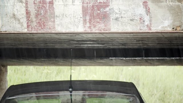 Car passing a low bridge close miss