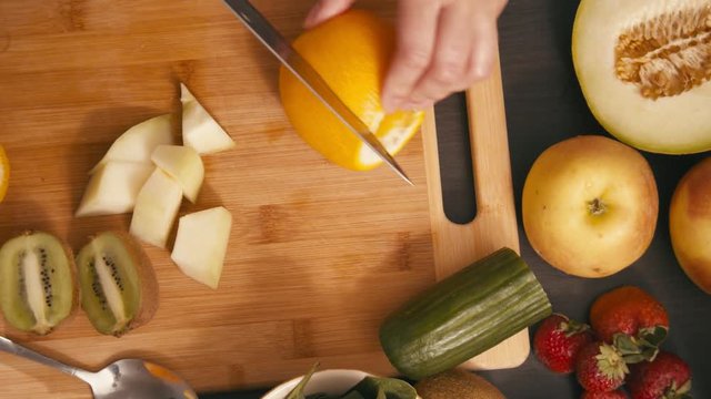 Cutting orange to make a healthy juice smoothie