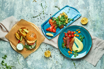 Three dishes with meat burger with grilled vegetables