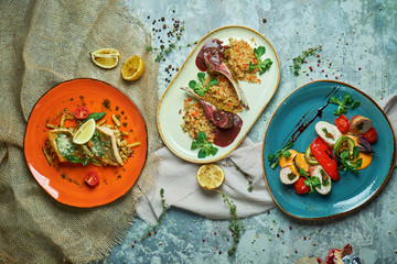 Three dishes with lamb ribs grilled fish