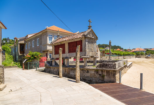 Combarro, Spain. Traditional horreo barn and stone cross in the old town