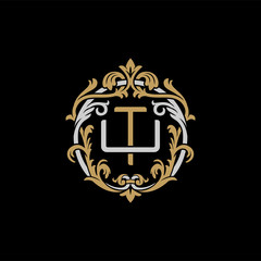 Initial letter U and T, UT, TU, decorative ornament emblem badge, overlapping monogram logo, elegant luxury silver gold color on black background