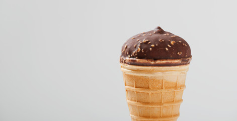 Glazed chocolate  ice cream scoop with cone isolated on white background.