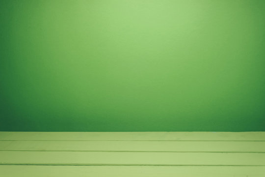 Beautiful Olive Wooden Table And Green Wall Background.