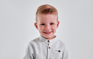 Little boy on gray background