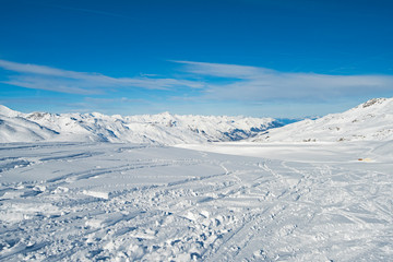 Panoramic view down snow covered valley in alpine mountain range