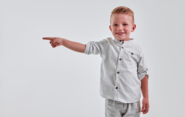 Little boy on gray background