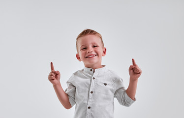 Little boy on gray background