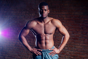 Fototapeta premium young muscular african american man doing push-ups and looking away