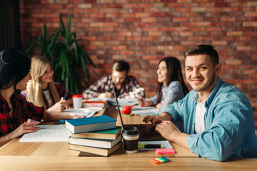 Group of university students sitting at the table