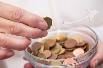 woman's hands holding jar of coins and entering a, savings concept