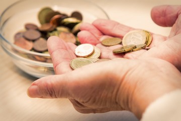 hands with coins and jar of coins, retirement concept