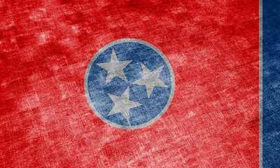 The national flag of the US state Tennessee in against a gray textile rag on the day of independence in different colors of blue red and yellow. Political and religious disputes, customs and delivery.