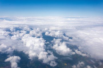 Naklejka na ściany i meble Earth in the airplane window with clouds
