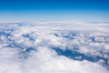 Fototapeta na wymiar Earth in the airplane window with clouds