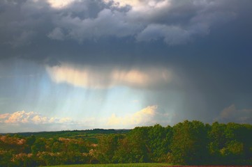 Fototapeta na wymiar Raining and storm clouds above the fields