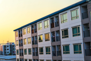 Naklejka premium Condominium block city building sunset sky