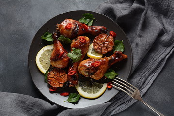 Grilled chicken legs with spices, parsley, garlic and lemon. Barbecue chicken concept 