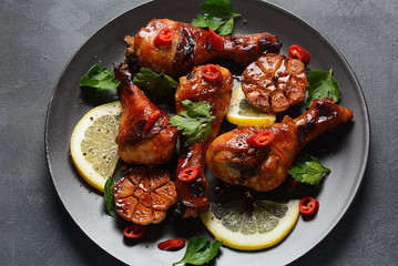 Grilled chicken legs with spices, parsley, garlic and lemon. Barbecue chicken concept 