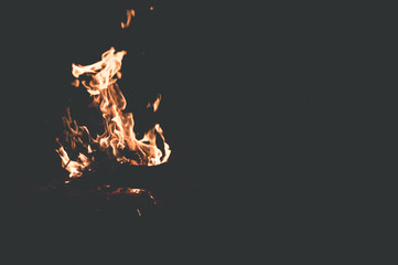 bonfire with tongues of flame on black background