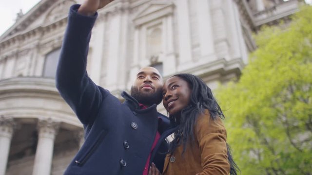 Attractive black couple pose for a selfie together whilst on a date