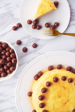 Layered cake decorated with chocolates and gold fork