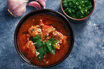 Kharcho soup - national Georgian cuisine dish with beef, rice, garlic and tkemali sauce. Traditional authentic Caucasian food. Copy space for text