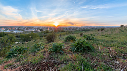 Photo during the sunset of the city of Leon, Spain,  from the place known as las lomas  with the sun in the background creating a spectacular atmosphere