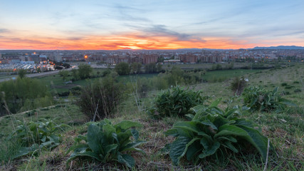 Photo during the sunset of the city of Leon, Spain,  from the place known as las lomas  with the sun in the background creating a spectacular atmosphere