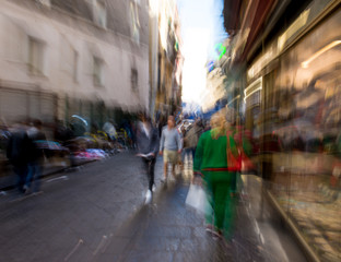 Naklejka na ściany i meble Busy city people going along the street. Intentional motion blur