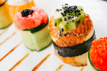 Sushi rolls on plate. Different gourmet seafood delicatessen. Japanese food art, culinary blog, fusion restaurant menu